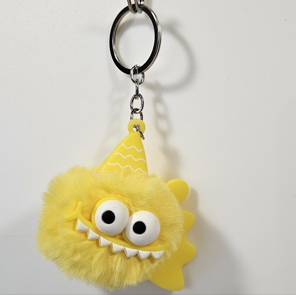 Yellow Monster Puff Keychain – Cute Fuzzy Charm with Party Hat